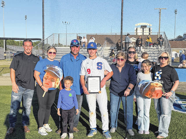 Scotland seniors Kaden Hunsucker, Dawson Williams and Blaine Callahan poses with family after being recognized for Senior Night on April 27, 2026.
                                 Travis Petty Jr | The Laurinburg Exchange