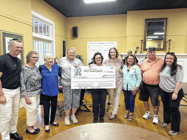 Members of the Hospice of Scotland County Annual Golf Tournament hold up a ceremonial check representing the total money raised on May 6, 2026.
                                 Travis Petty Jr | The Laurinburg Exchange