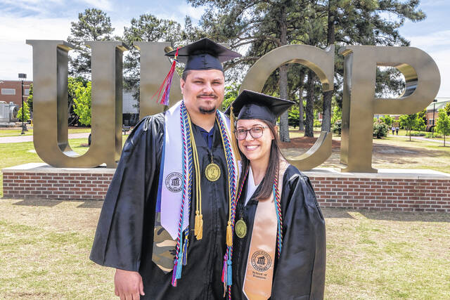 Married couple Ashley and Damian Ransom were set to cross the stage together at UNCP Commencement on Saturday.
                                 Courtesy photo | UNCP